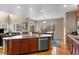 Open kitchen with stainless steel appliances, granite countertops, and access to living and dining areas at 16685 E 101St Ave, Commerce City, CO 80022