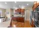 Spacious kitchen features stainless steel appliances, granite countertops, and hardwood floors at 16685 E 101St Ave, Commerce City, CO 80022