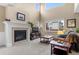 Bright living room with a cozy fireplace, large windows, and comfortable seating, creating a welcoming atmosphere at 16685 E 101St Ave, Commerce City, CO 80022