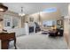 Bright living room with fireplace, and large windows that provide ample natural light and views of the neighborhood at 16685 E 101St Ave, Commerce City, CO 80022
