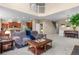 Open-concept living room with plush seating, high ceilings, and easy access to kitchen and dining area at 16685 E 101St Ave, Commerce City, CO 80022