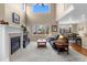 Spacious living room with fireplace, and open floor plan with easy access to the kitchen and dining area at 16685 E 101St Ave, Commerce City, CO 80022