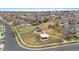 Aerial view of a well-maintained park with walking paths and playground equipment for outdoor recreation at 16685 E 101St Ave, Commerce City, CO 80022