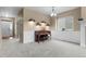 Elegant sitting area featuring wainscoting, stylish light fixtures, and large window at 16685 E 101St Ave, Commerce City, CO 80022