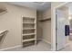 Bright walk-in closet with shelving and hanging space, offering ample storage and organization, leading to the bathroom at 16685 E 101St Ave, Commerce City, CO 80022