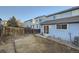 Outdoor view of light blue home featuring a fenced-in yard, sliding glass door, and air conditioning unit at 11039 Columbine St, Northglenn, CO 80233
