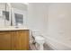 Bright bathroom features a shower-tub combo, white tile backsplash, and wood-grain vanity at 11039 Columbine St, Northglenn, CO 80233