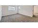 A bright bedroom featuring two windows for natural light and plush carpeting at 11039 Columbine St, Northglenn, CO 80233
