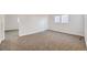 Bedroom showing neutral carpet, white walls and baseboards, and a double-hung window at 11039 Columbine St, Northglenn, CO 80233