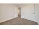 Bright bedroom featuring closet, plush carpet, light walls, and an open doorway to an ensuite bathroom at 11039 Columbine St, Northglenn, CO 80233