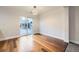 Dining room with hardwood floors, sliding glass doors, and a modern chandelier at 11039 Columbine St, Northglenn, CO 80233