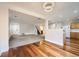 Open-concept living room featuring wood and carpet flooring and a modern light fixture at 11039 Columbine St, Northglenn, CO 80233