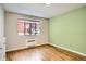 This bedroom features hardwood floors, natural light, and neutral paint at 1000 E 8Th Ave # 4, Denver, CO 80218