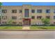 A three-story residential brick building with a distinctive art deco entrance and manicured lawn at 1000 E 8Th Ave # 4, Denver, CO 80218