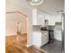 Bright kitchen adjacent to living space features stone countertops, white cabinets, and stainless steel appliances at 1000 E 8Th Ave # 4, Denver, CO 80218