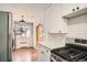 Modern kitchen with stainless appliances, white cabinets, subway tile backsplash, and hardwood floors at 1000 E 8Th Ave # 4, Denver, CO 80218