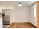 Cozy kitchen with stainless steel fridge, white cabinets, hardwood floors and eating space next to window at 1000 E 8Th Ave # 4, Denver, CO 80218