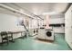 Shared laundry room with industrial machines, folding table, and natural light at 1000 E 8Th Ave # 4, Denver, CO 80218