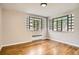 Bright living room features hardwood floors, modern light fixture, and windows letting in natural light at 1000 E 8Th Ave # 4, Denver, CO 80218