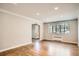 Well-lit living room with hardwood floors, arched doorways, large windows, and classic radiator creating a cozy feel at 1000 E 8Th Ave # 4, Denver, CO 80218
