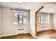 Living room with windows, radiators, and hardwood floors; arched entryway opens to an adjacent room at 1000 E 8Th Ave # 4, Denver, CO 80218