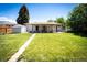Spacious backyard features a well-maintained lawn, covered patio, and convenient storage shed at 1183 S Umatilla St, Denver, CO 80223
