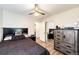 Comfortable bedroom featuring a mirrored closet, ceiling fan and built-in cabinet at 1183 S Umatilla St, Denver, CO 80223