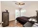 Cozy bedroom with a ceiling fan and a window bringing natural light to the room at 1183 S Umatilla St, Denver, CO 80223