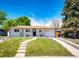 Charming one-story home featuring a well-manicured lawn and inviting walkway to the front door at 1183 S Umatilla St, Denver, CO 80223