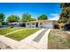 View of the front yard, driveway and single car garage of a charming house at 1183 S Umatilla St, Denver, CO 80223