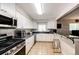Modern kitchen features stainless steel appliances, granite countertops and updated cabinets at 1183 S Umatilla St, Denver, CO 80223