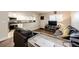 Comfortable living room features an open floor plan with adjacent kitchen at 1183 S Umatilla St, Denver, CO 80223