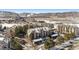 Scenic aerial view of a condo community featuring well-maintained buildings, landscaping, and snow-capped mountains at 7375 S Alkire St # 102, Littleton, CO 80127