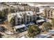 Beautiful aerial view of residential community with well-kept grounds, carports and snow covered landscape at 7375 S Alkire St # 102, Littleton, CO 80127