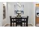 Dining room featuring wood floors, a modern chandelier, and seating for four at 7375 S Alkire St # 102, Littleton, CO 80127