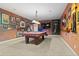Finished basement with a pool table, brick accent wall, and custom decor at 6420 Agave Ave, Castle Rock, CO 80108