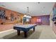 Spacious basement featuring a pool table with custom decor and a bar at 6420 Agave Ave, Castle Rock, CO 80108