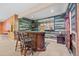 Basement bar with seating and a television is the perfect spot to relax and enjoy the game at 6420 Agave Ave, Castle Rock, CO 80108