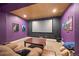 Home theater room featuring a large screen, comfortable seating, and purple walls at 6420 Agave Ave, Castle Rock, CO 80108
