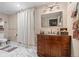 Bright bathroom featuring a wood vanity, marble floors, and modern fixtures for a luxurious and stylish feel at 6420 Agave Ave, Castle Rock, CO 80108