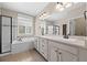 Bright bathroom featuring double sinks, soaking tub, and walk-in shower with modern finishes at 6420 Agave Ave, Castle Rock, CO 80108