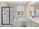 Bright bathroom showcasing a soaking tub and walk-in shower with black trim at 6420 Agave Ave, Castle Rock, CO 80108