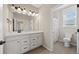 Well-lit bathroom features double vanity, and a walk-in shower with modern fixtures at 6420 Agave Ave, Castle Rock, CO 80108