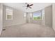 Spacious bedroom with large windows, neutral carpet, and a modern ceiling fan for added comfort at 6420 Agave Ave, Castle Rock, CO 80108
