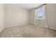 Cozy bedroom features neutral carpet, a large window with bright natural light, and ample space at 6420 Agave Ave, Castle Rock, CO 80108