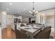 Dining area connected to kitchen with set table, modern appliances, and hardwood floors at 6420 Agave Ave, Castle Rock, CO 80108