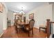 Elegant dining room with hardwood floors, chandelier, and ornate wood furniture and cabinet for a luxurious touch at 6420 Agave Ave, Castle Rock, CO 80108