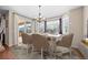 Bright dining room features modern chandelier, stylish chairs, and sliding glass door to the patio at 6420 Agave Ave, Castle Rock, CO 80108