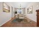 Stylish dining room features hardwood floors, modern art, and sophisticated light fixture at 6420 Agave Ave, Castle Rock, CO 80108