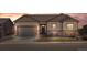 Inviting single-story home boasting beautiful stonework, a well-manicured lawn, and a charming front porch seating area at 6420 Agave Ave, Castle Rock, CO 80108